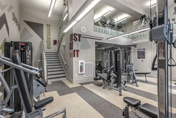 a spacious fitness center with treadmills and other exercise equipment